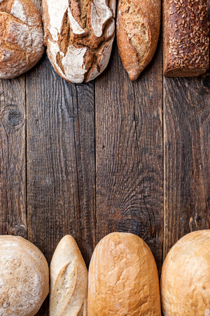 Delicious freshly baked bread on wooden backgroundの写真素材