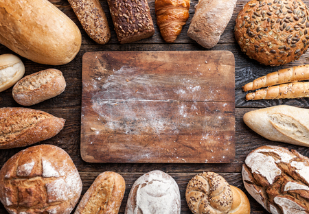Delicious freshly baked bread on wooden backgroundの写真素材