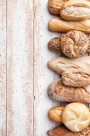 Delicious freshly baked bread on wooden backgroundの写真素材