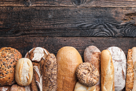Delicious freshly baked bread on wooden backgroundの写真素材