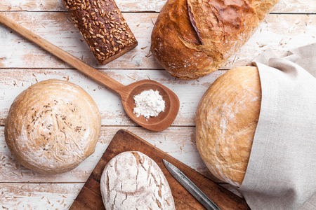Delicious freshly baked bread on wooden backgroundの写真素材