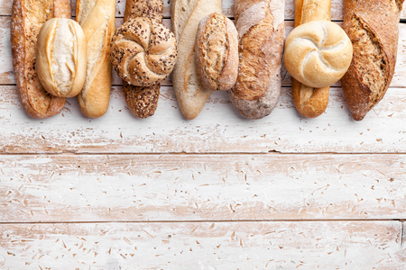 Delicious freshly baked bread on wooden backgroundの写真素材