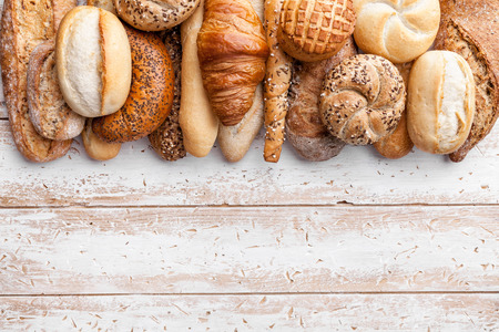Delicious freshly baked bread on wooden backgroundの写真素材