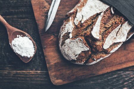 Delicious freshly baked bread on wooden backgroundの写真素材