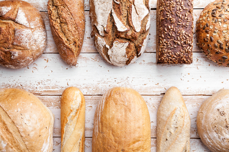 Delicious freshly baked bread on wooden backgroundの写真素材