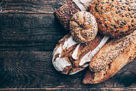 Delicious freshly baked bread on wooden backgroundの写真素材