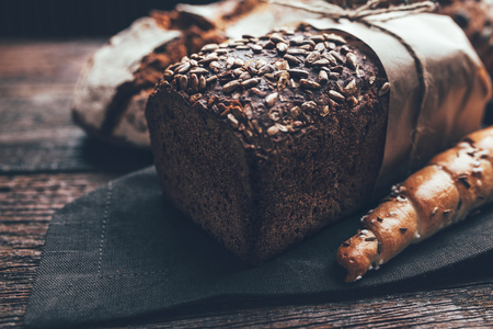 Delicious freshly baked bread on wooden backgroundの写真素材