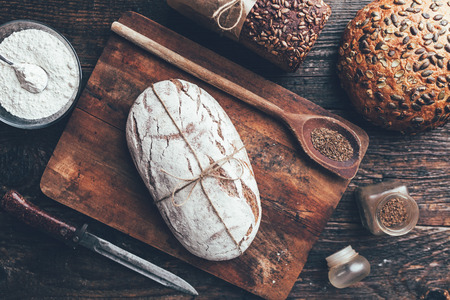 Delicious freshly baked bread on wooden backgroundの写真素材