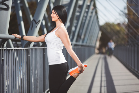 City workout. Beautiful young woman training in an urban settingの写真素材