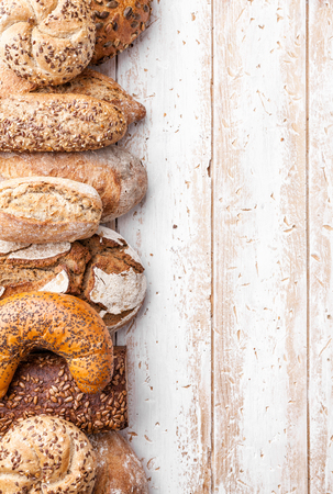 Delicious freshly baked bread on wooden backgroundの写真素材