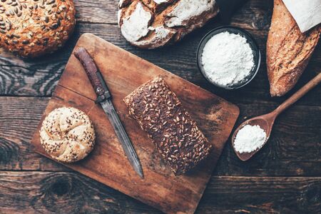 Delicious freshly baked bread on wooden backgroundの写真素材
