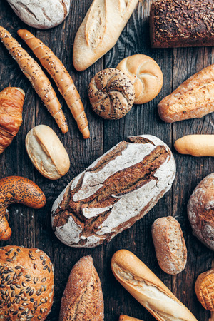 Delicious freshly baked bread on wooden backgroundの写真素材