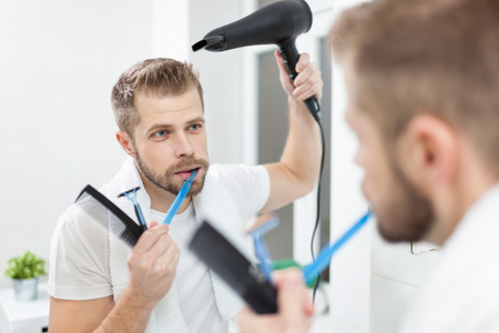 Morning hygiene, Handsome man in the bathroom and his morning routineの写真素材