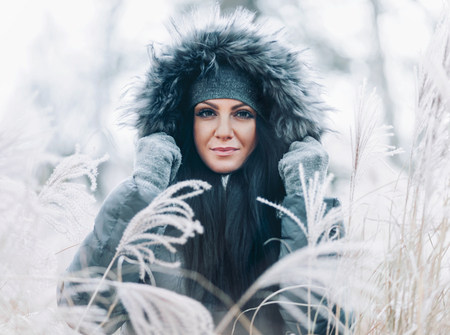 Beautiful young woman wearing a fur hood winter coatの写真素材