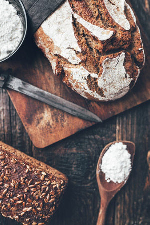 Delicious freshly baked bread on wooden backgroundの写真素材