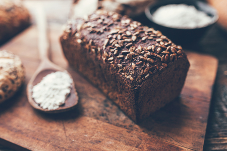 Delicious freshly baked bread on wooden backgroundの写真素材