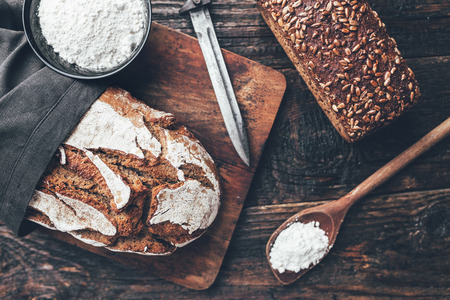 Delicious freshly baked bread on wooden backgroundの写真素材
