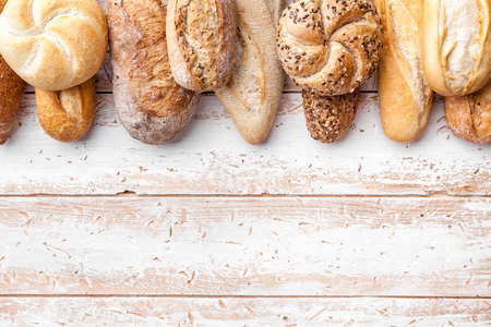 Delicious freshly baked bread on wooden backgroundの写真素材