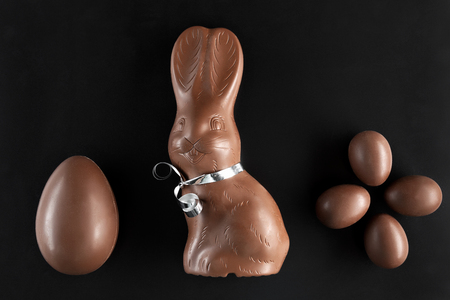 Delicious chocolate Easter bunny and eggs on dark backgroundの写真素材