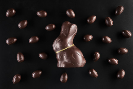 Delicious chocolate Easter bunny and eggs on dark backgroundの写真素材