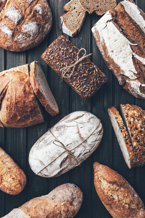 Delicious freshly baked bread on wooden backgroundの写真素材