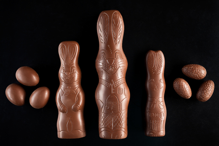 Delicious chocolate Easter bunny and eggs on dark backgroundの写真素材