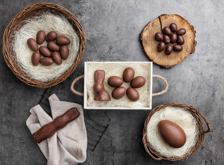 Delicious chocolate Easter bunny and eggs on rustic backgroundの写真素材