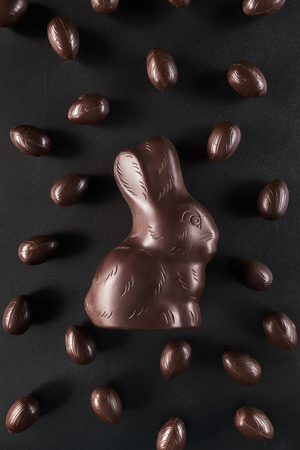 Delicious chocolate Easter bunny and eggs on dark backgroundの写真素材