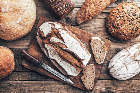 Delicious freshly baked bread on wooden backgroundの写真素材
