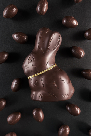 Delicious chocolate Easter bunny and eggs on dark backgroundの写真素材