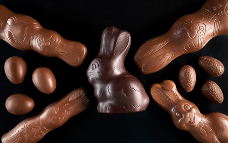 Delicious chocolate Easter bunny and eggs on dark backgroundの写真素材