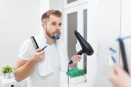 Morning hygiene, Handsome man in the bathroom and his morning routineの写真素材