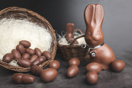 Delicious chocolate Easter bunny and eggs on rustic backgroundの写真素材