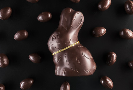 Delicious chocolate Easter bunny and eggs on dark backgroundの写真素材