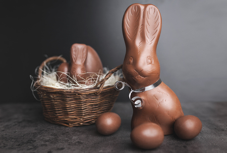 Delicious chocolate Easter bunny and eggs on rustic backgroundの写真素材
