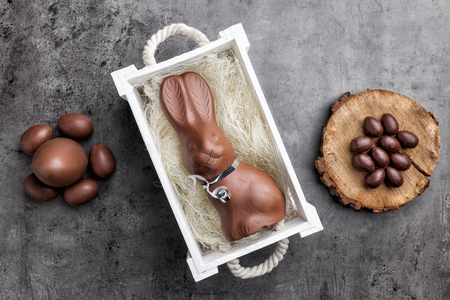 Delicious chocolate Easter bunny and eggs on rustic backgroundの写真素材