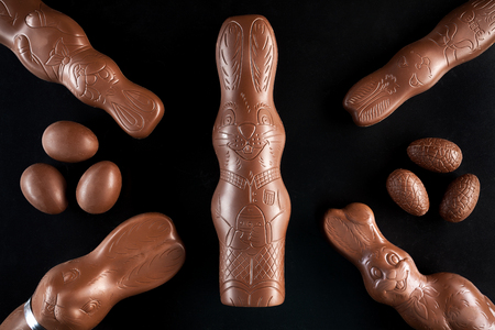 Delicious chocolate Easter bunny and eggs on dark backgroundの写真素材