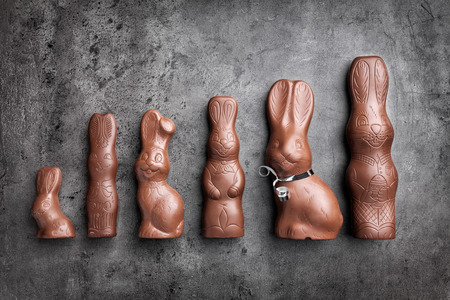 Variety of delicious chocolate Easter bunnies on rustic backgroundの写真素材