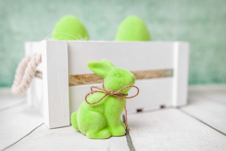 Traditional Easter holiday basket with a bunny and eggsの写真素材