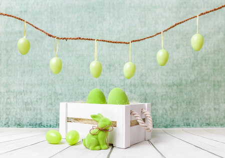 Traditional Easter holiday basket with a bunny and eggsの写真素材