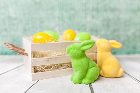 Traditional Easter holiday basket with a bunny and eggsの写真素材