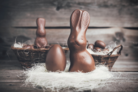 Delicious chocolate Easter bunny and eggs on wooden backgroundの写真素材