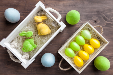 Traditional Easter holiday basket with a bunny and eggsの写真素材