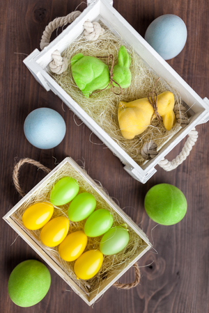 Traditional Easter holiday basket with a bunny and eggsの写真素材