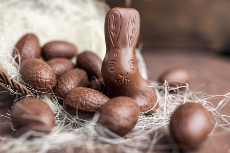 Delicious chocolate Easter bunny and eggs on wooden backgroundの写真素材
