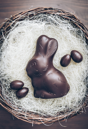 Delicious chocolate Easter bunny inside a basketの写真素材