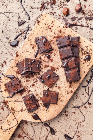 Delicious dark chocolate pieces with cocoa powderの写真素材