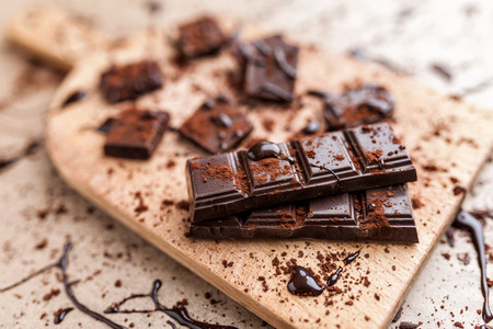 Delicious dark chocolate pieces with cocoa powderの写真素材