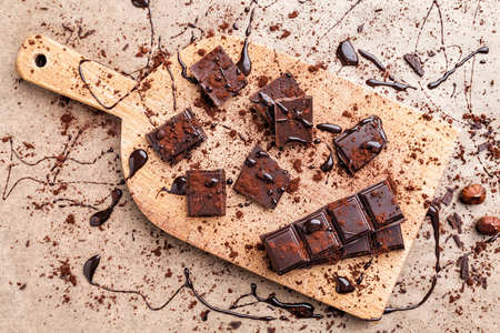 Delicious dark chocolate pieces with cocoa powderの写真素材