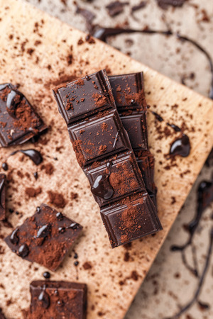 Delicious dark chocolate pieces with cocoa powderの写真素材